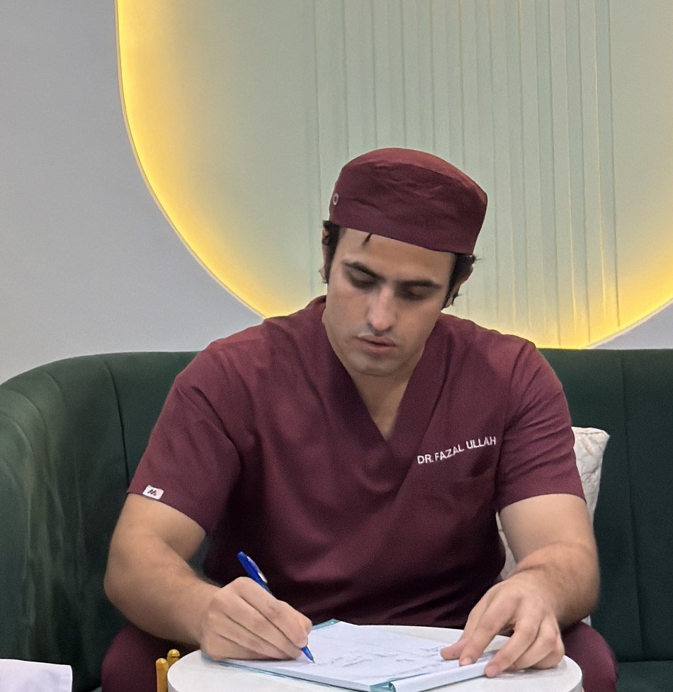 Dr. Fazal Ullah consulting a patient at DENTOSPHERE